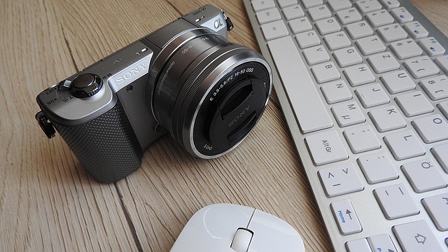 Camera beside a mouse and keyboard