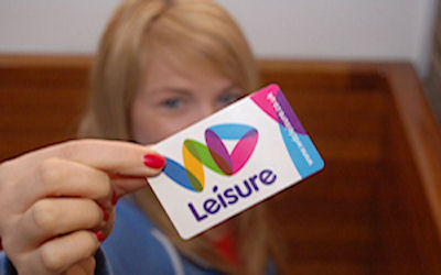 Woman holding a Passport to Leisure card - WDL logo on the card