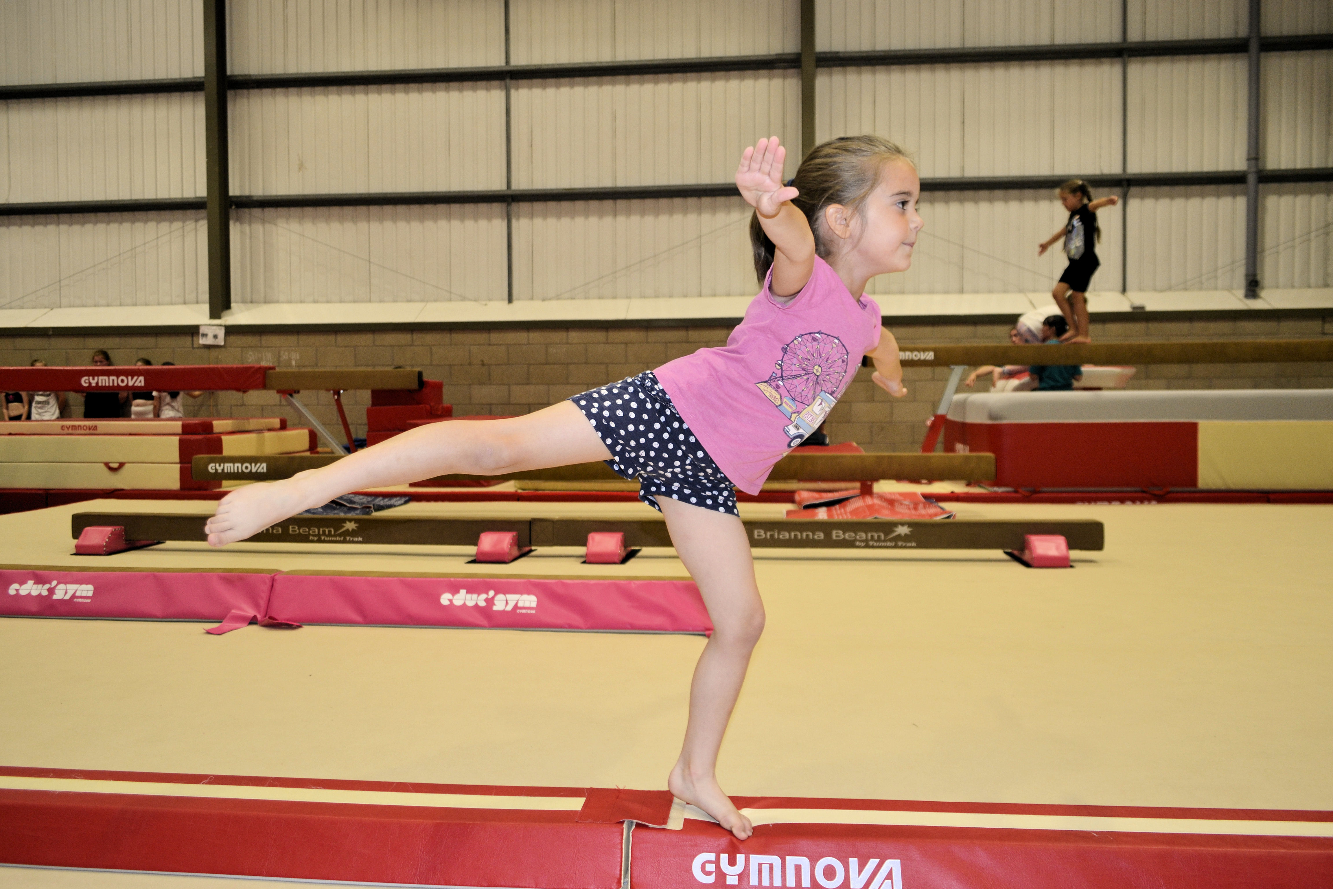 image of Gymnastics - girl balancing on a childs balance beam