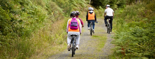 4 people riding bikes in the country