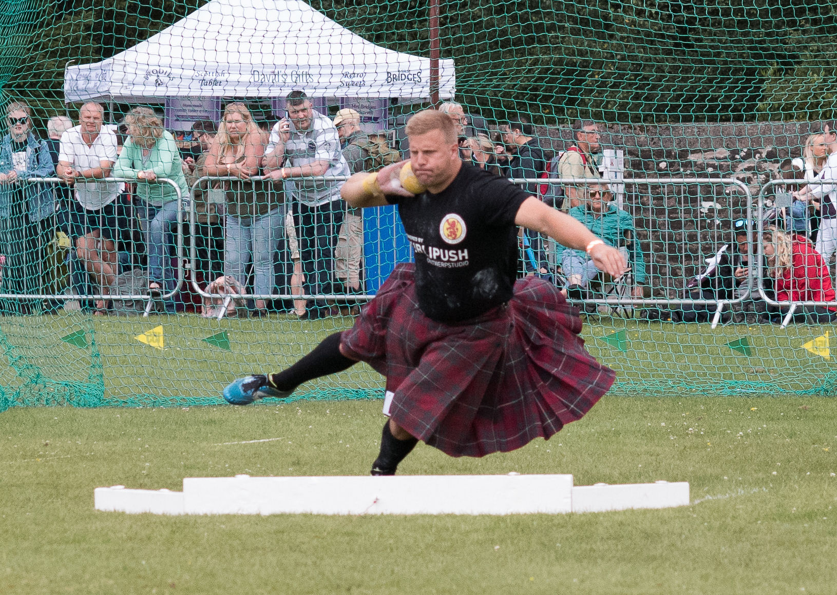 Highland Games winding up for the shot put