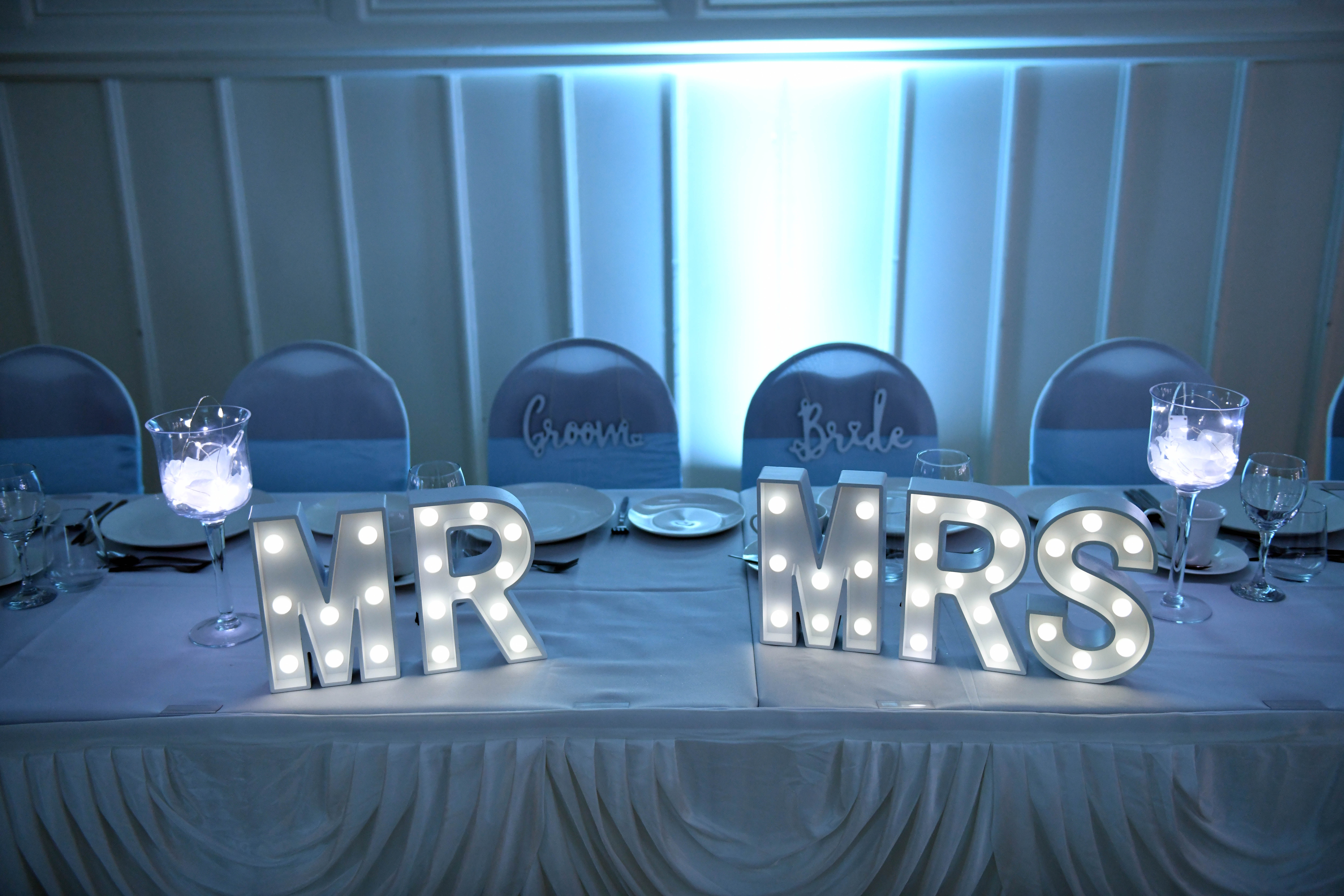 image of Venue Dressing - white MR and MRS lights on head table