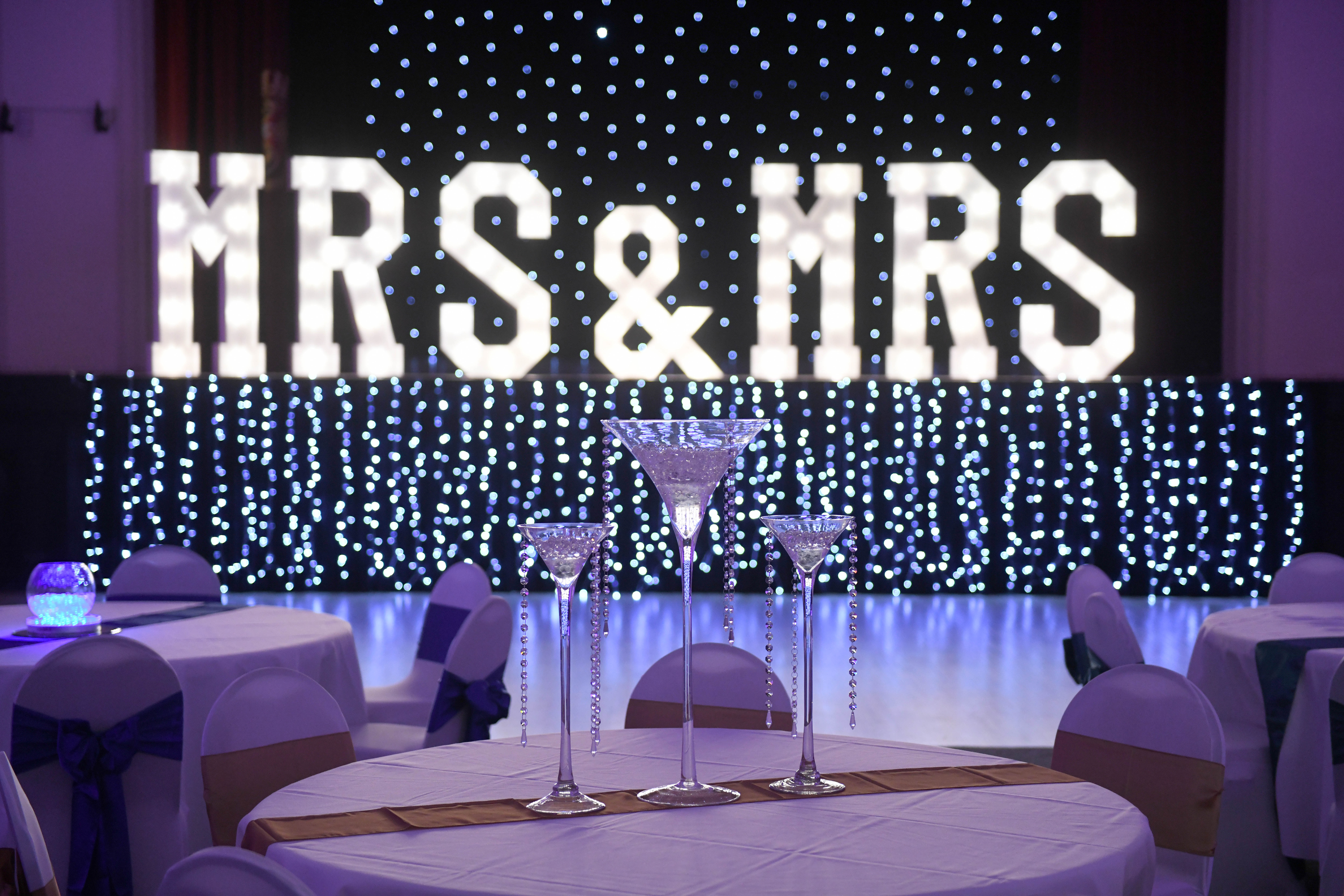 image of Venue Dressing - MRS & MRS on the stage in lights