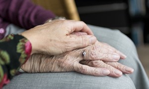 Holding elderly persons hand