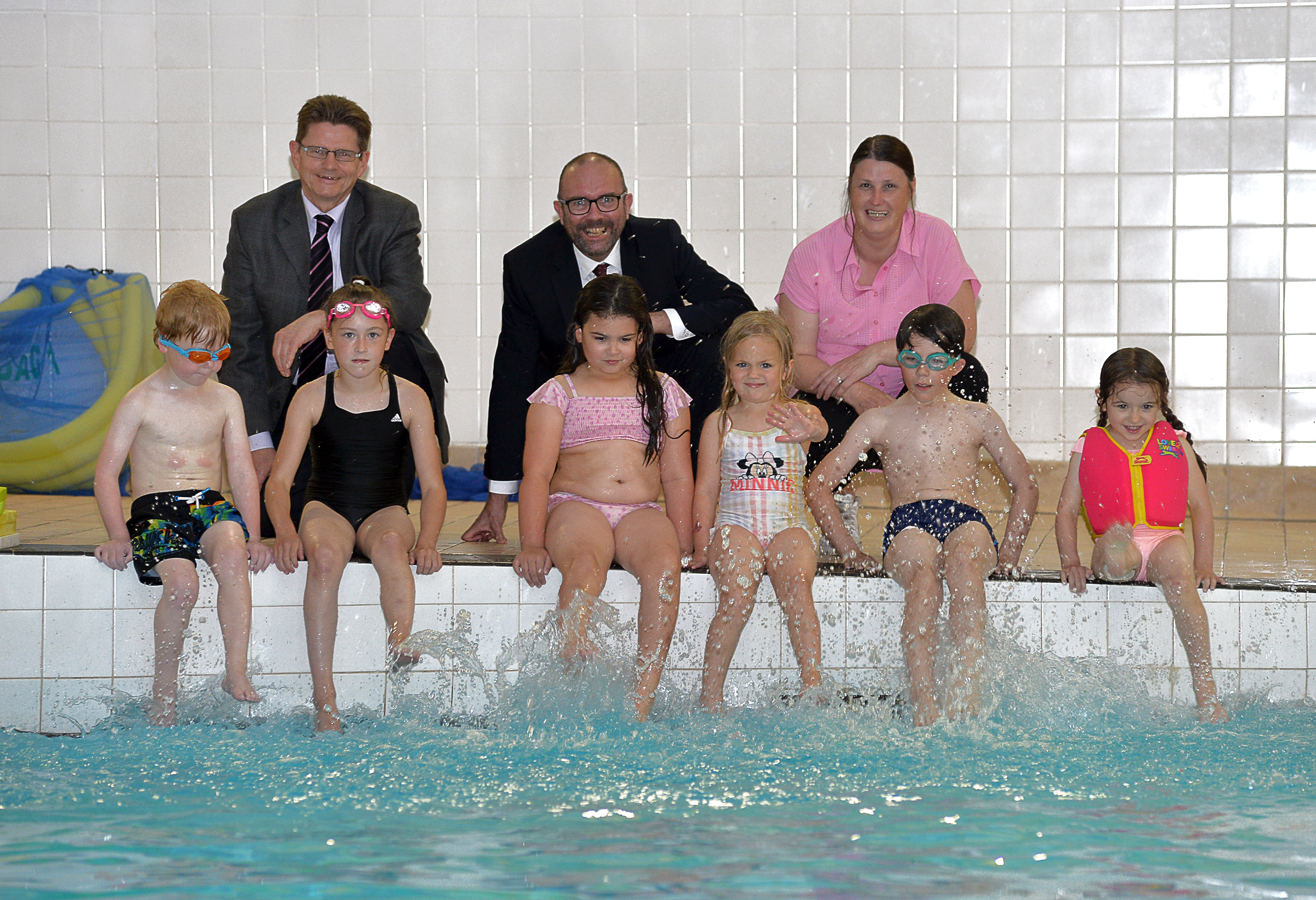 Councillors with some young people at a swimming lesson