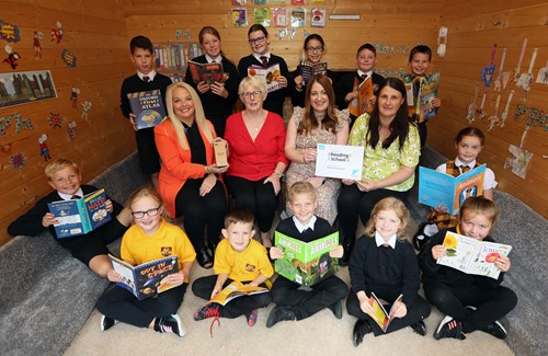 Councillor Michelle McGinty, Vice Chair of Educational Services and lots of young people reading books