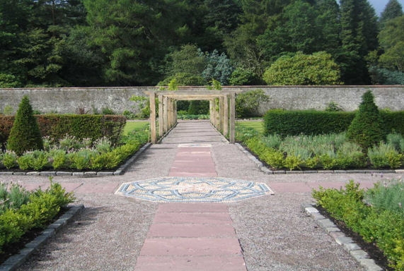 Walled Garden After - path repaired, new trellis, dead trees removed and plants planted