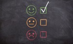 smiling face with tick, glum face and a sad face