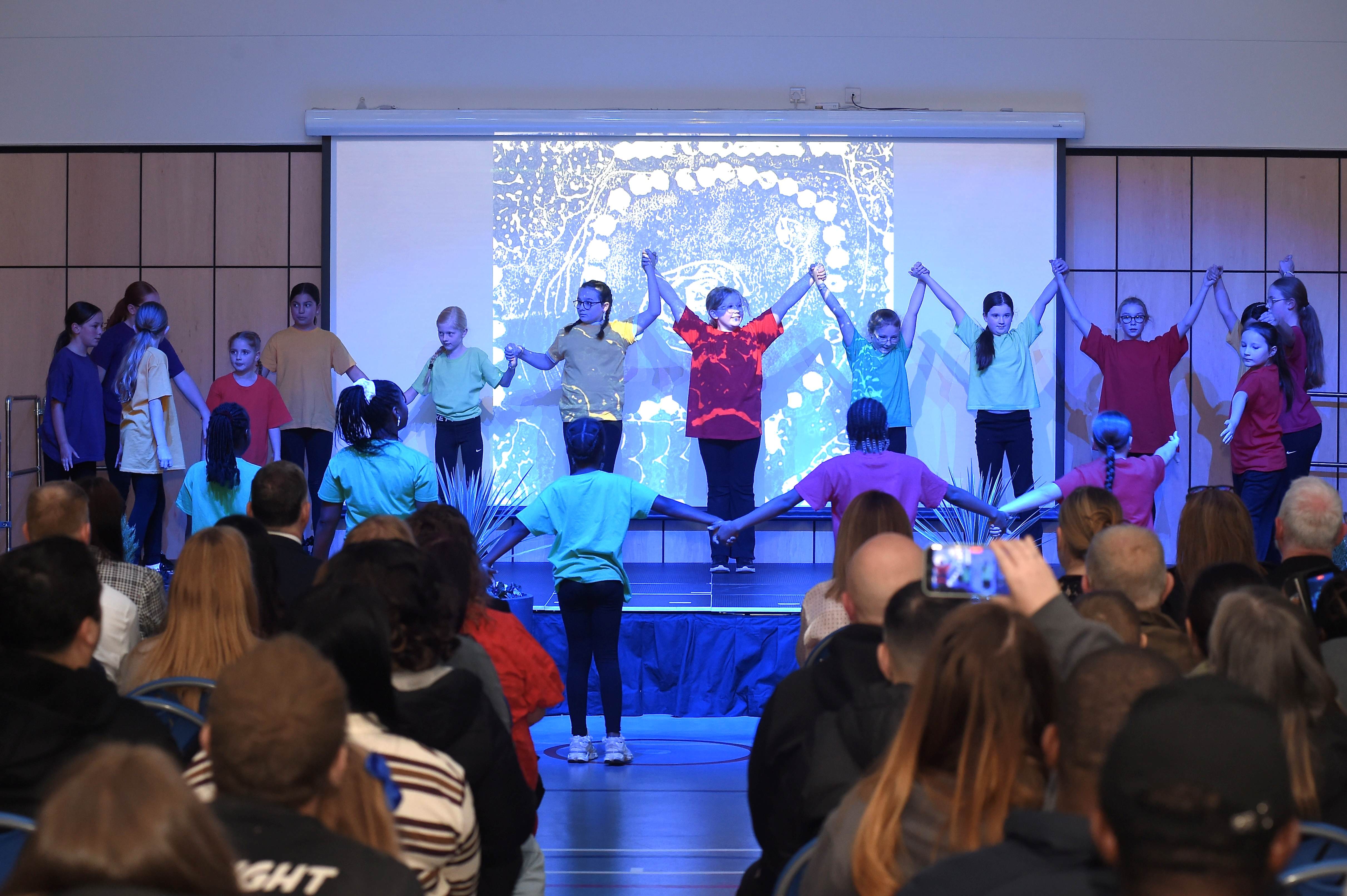 Dancers on stage during opening event at Faifley Campus