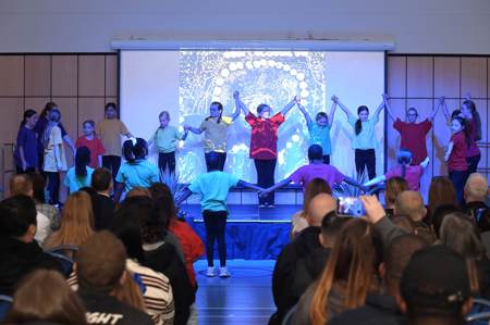Dancers on stage during opening event at Faifley Campus