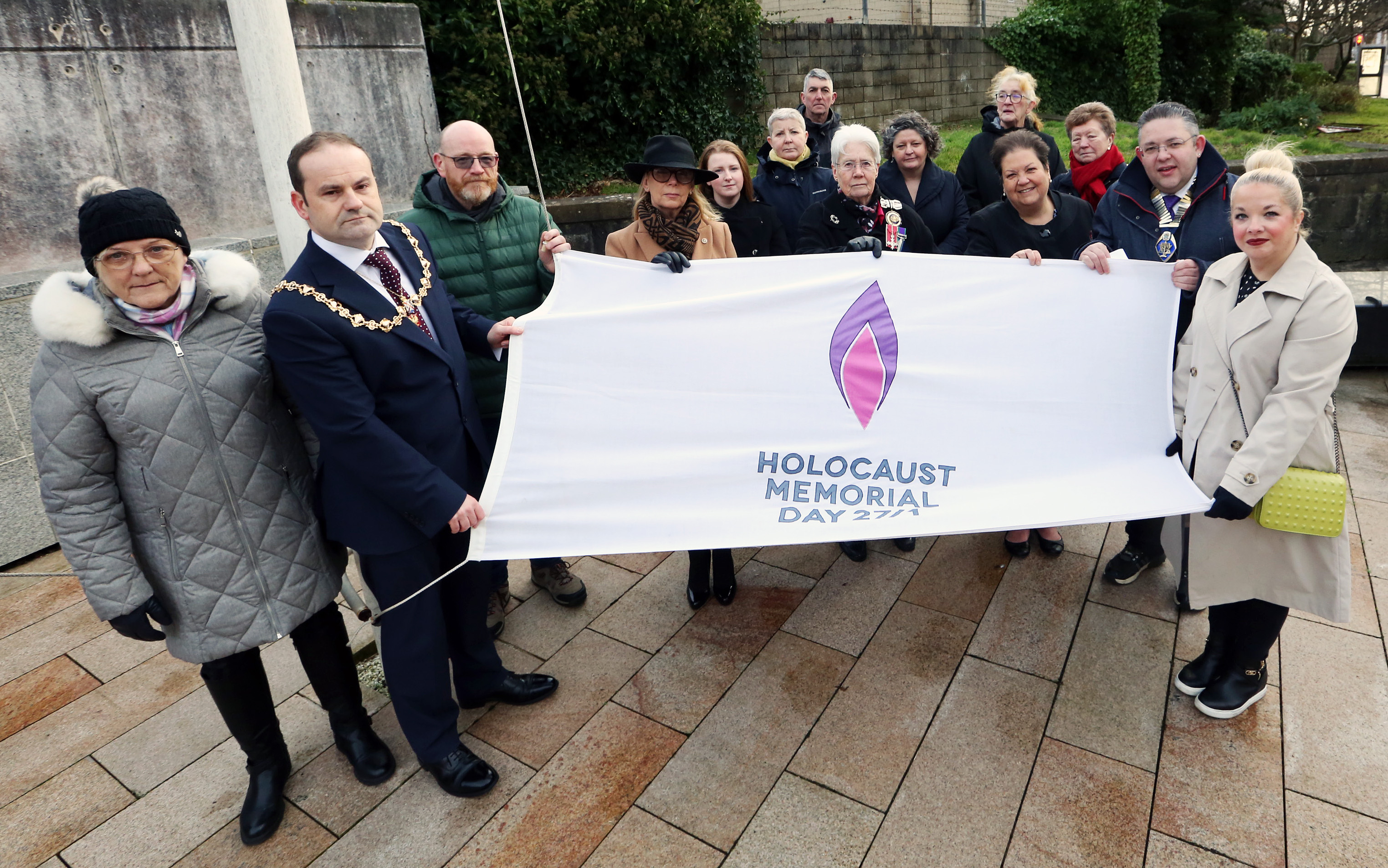 Provost, Deputy Lord Lieutenant, Councillors and guests holding Holocaust Memorial Day flag