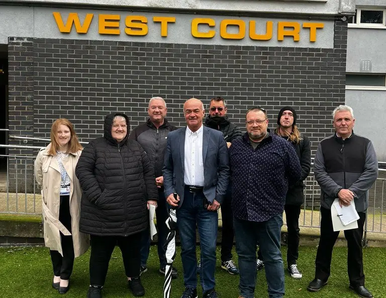Group of tenants and council staff on a walkabout at West Court.