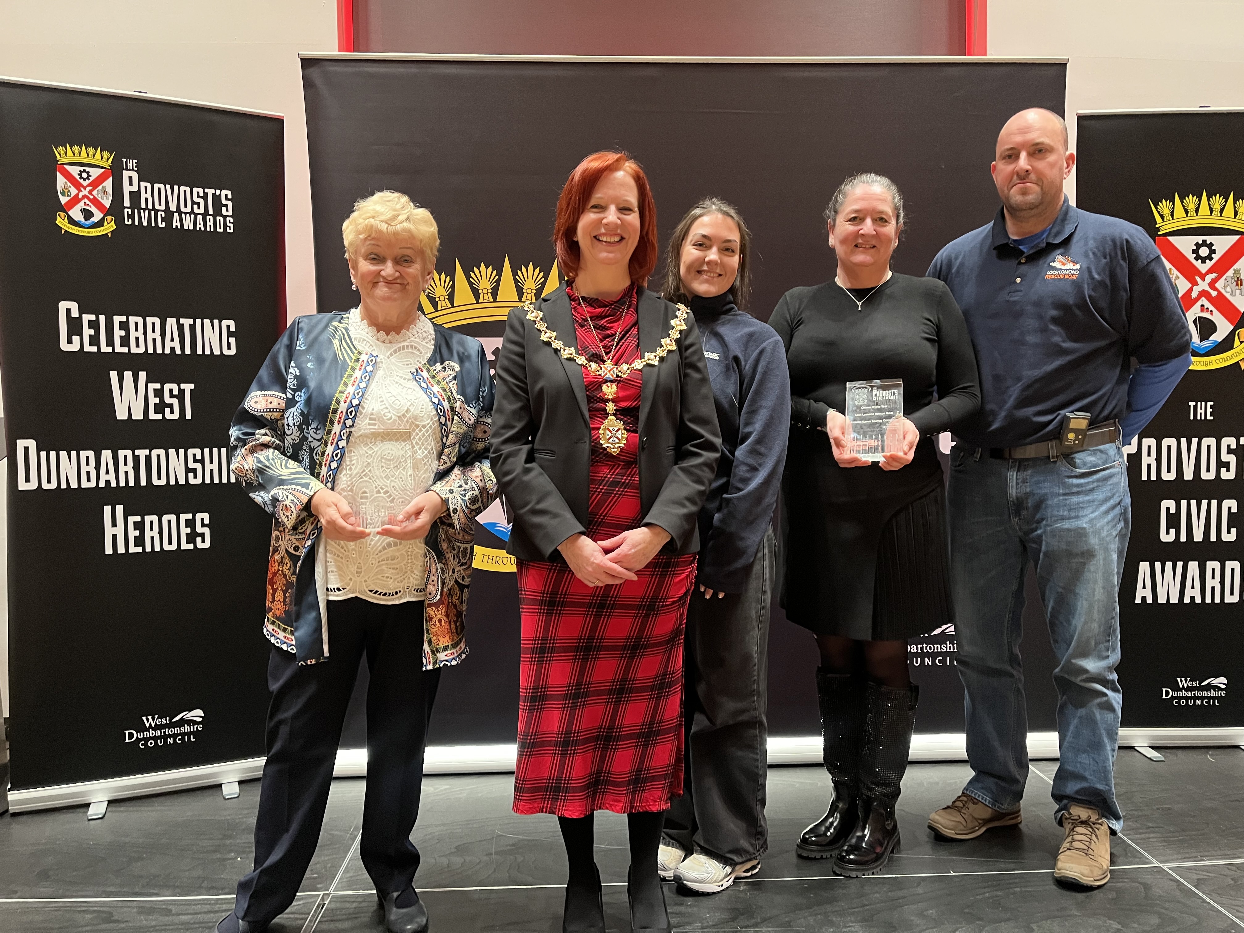 Provost Karen Murray Conaghan on stage with winners Annette McPhie and Loch Lomond Rescue Boat Volunteers