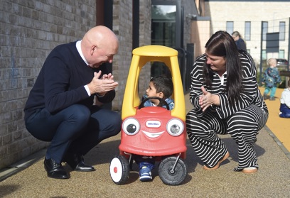 Councillor John Millar and Councillor Michelle McGinty alongside a child in a toy car