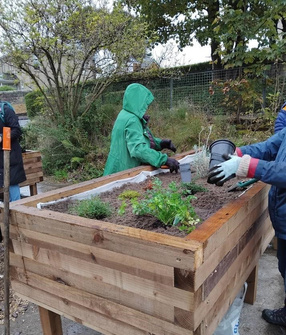 Photo of volunteers working on a raised planter in Parkhall.
