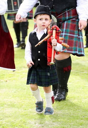 Little boy marching with pipe band