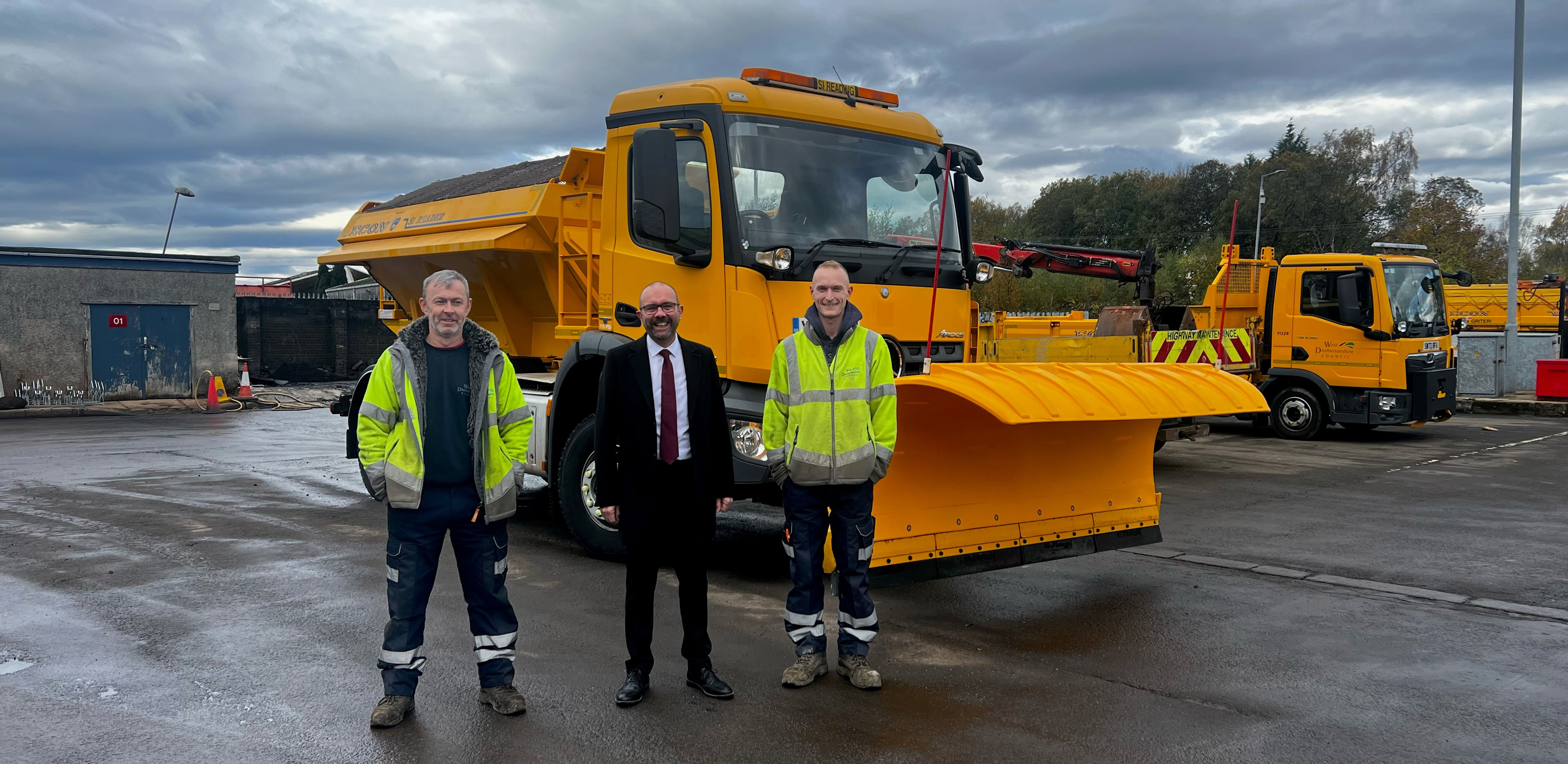 Councillor McBride stands with two members of the roads team in front of gritter