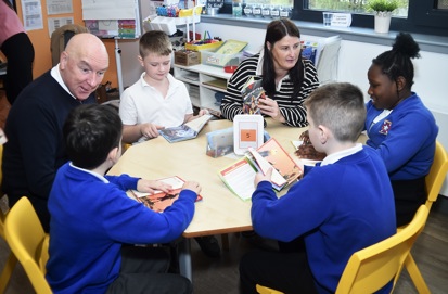 Councillor John Millar and Councillor Michelle McGinty at table reading with school pupils
