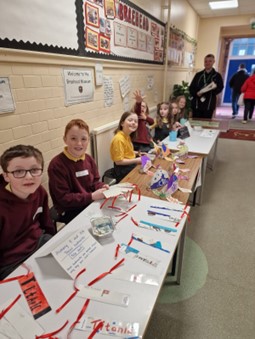 young people sitting at a desk working on their 'A Day at the Museum'