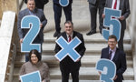 Council Leader Martin Rooney with seven other council leaders holding large numbers in Glasgow City Chambers
