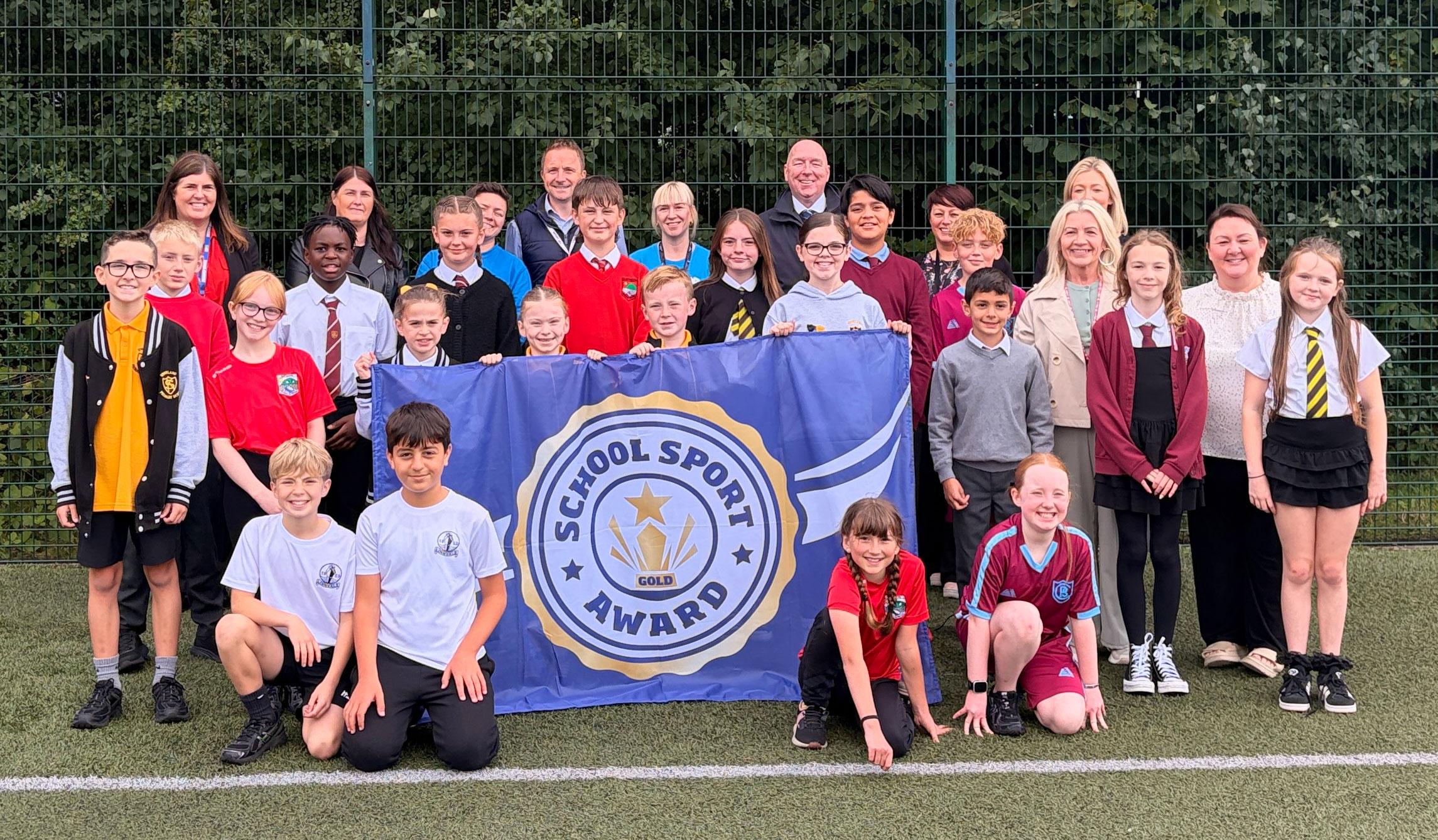Primary school pupils, teachers, councillors and Active Schools staff with Gold School Sport Awards in West Dunbartonshire.