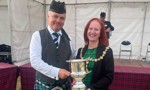Provost Karen Murray Conaghan presents winners trophy to Inverary and District Pipe Band