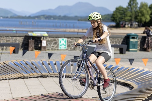 girl cycling on wooden bike track