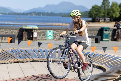 girl cycling on wooden bike track